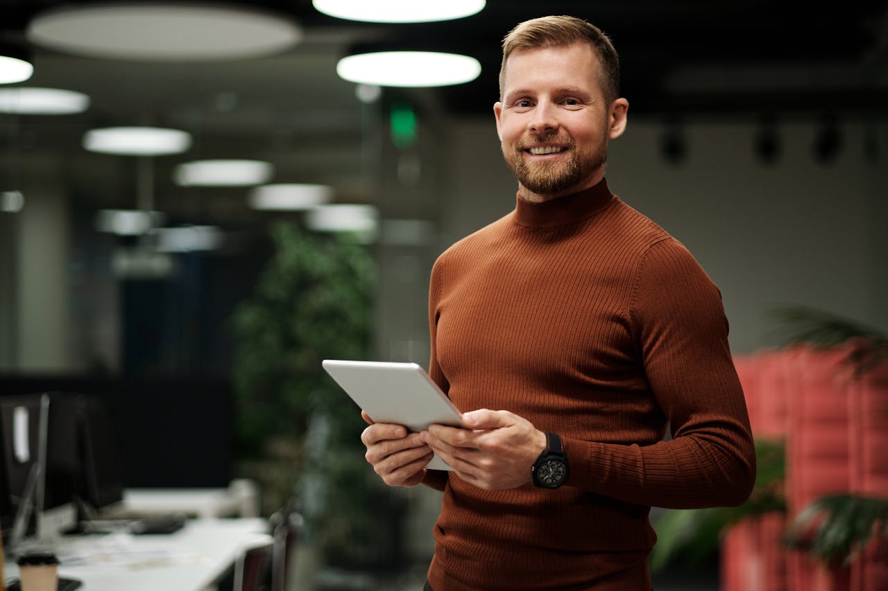 ecommerce investor in brown long sleeve shirt holding a silver tablet